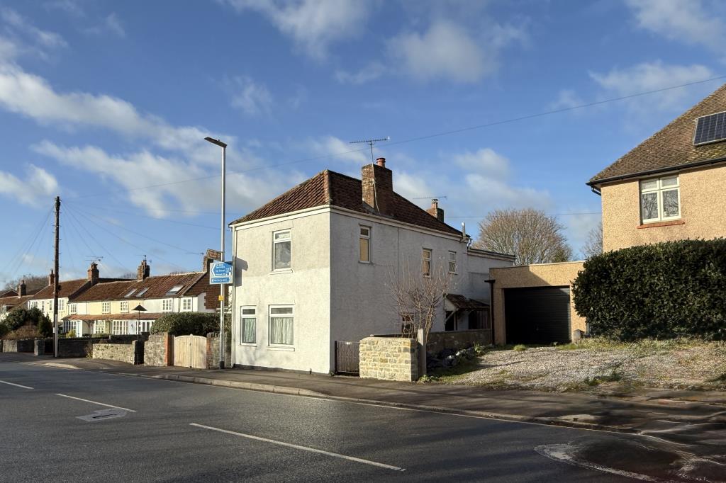 Lot: 125 - END-TERRACE TWO-BEDROOM HOUSE WITH REAR GARDEN FOR UPDATING - General view of the front of the property